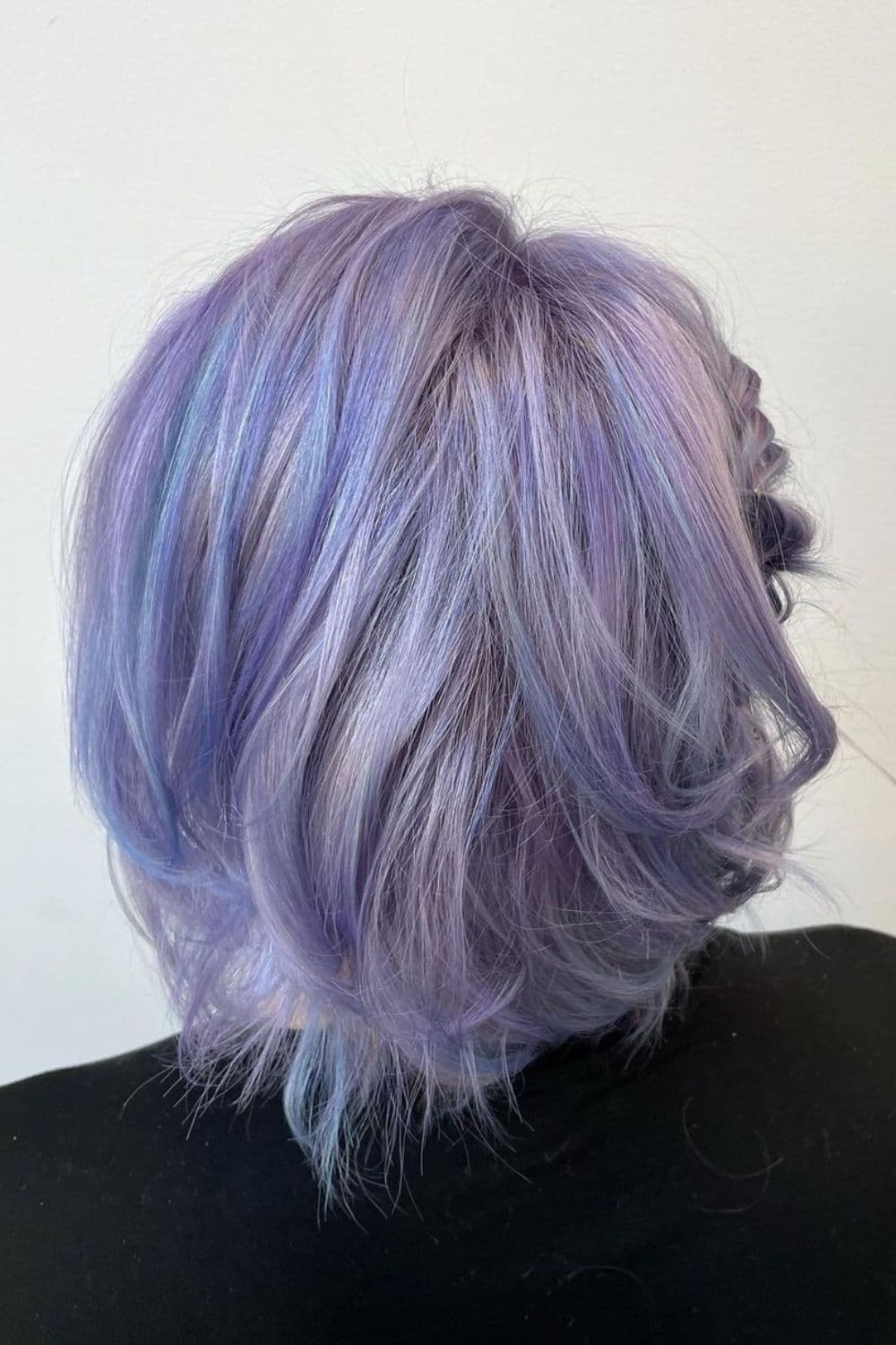 A woman with a lavender and silver blue bob cut.