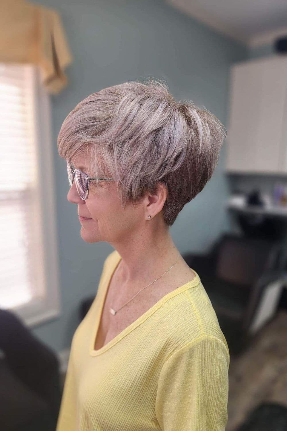 A woman with a gray layered pixie cut.