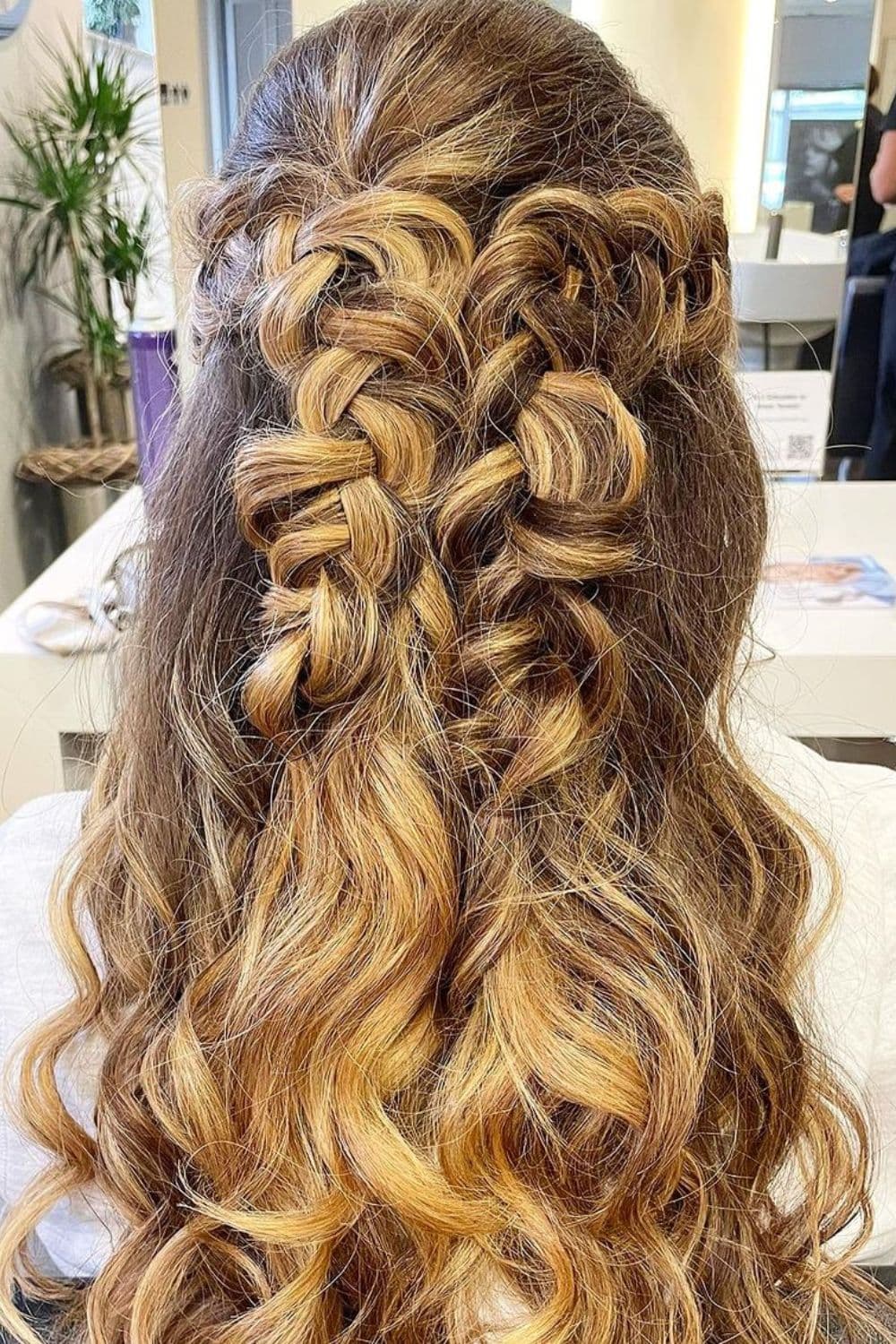 A woman with a blonde loose French braid.
