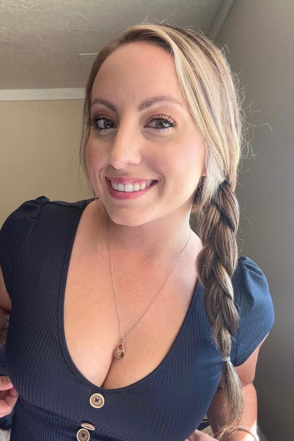 A woman with a loose blonde side braid.