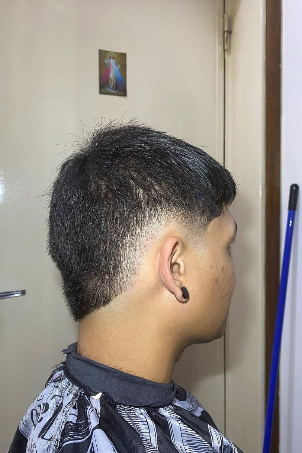 A man with a low burst fade cut.