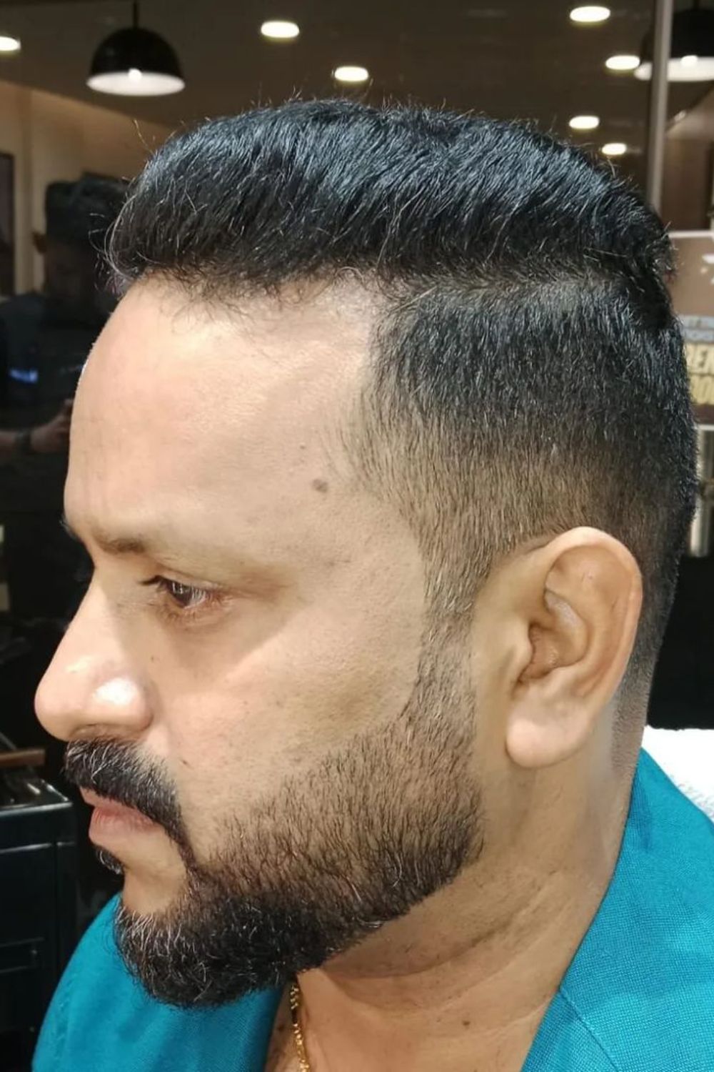A man with a low fade cut with beard.