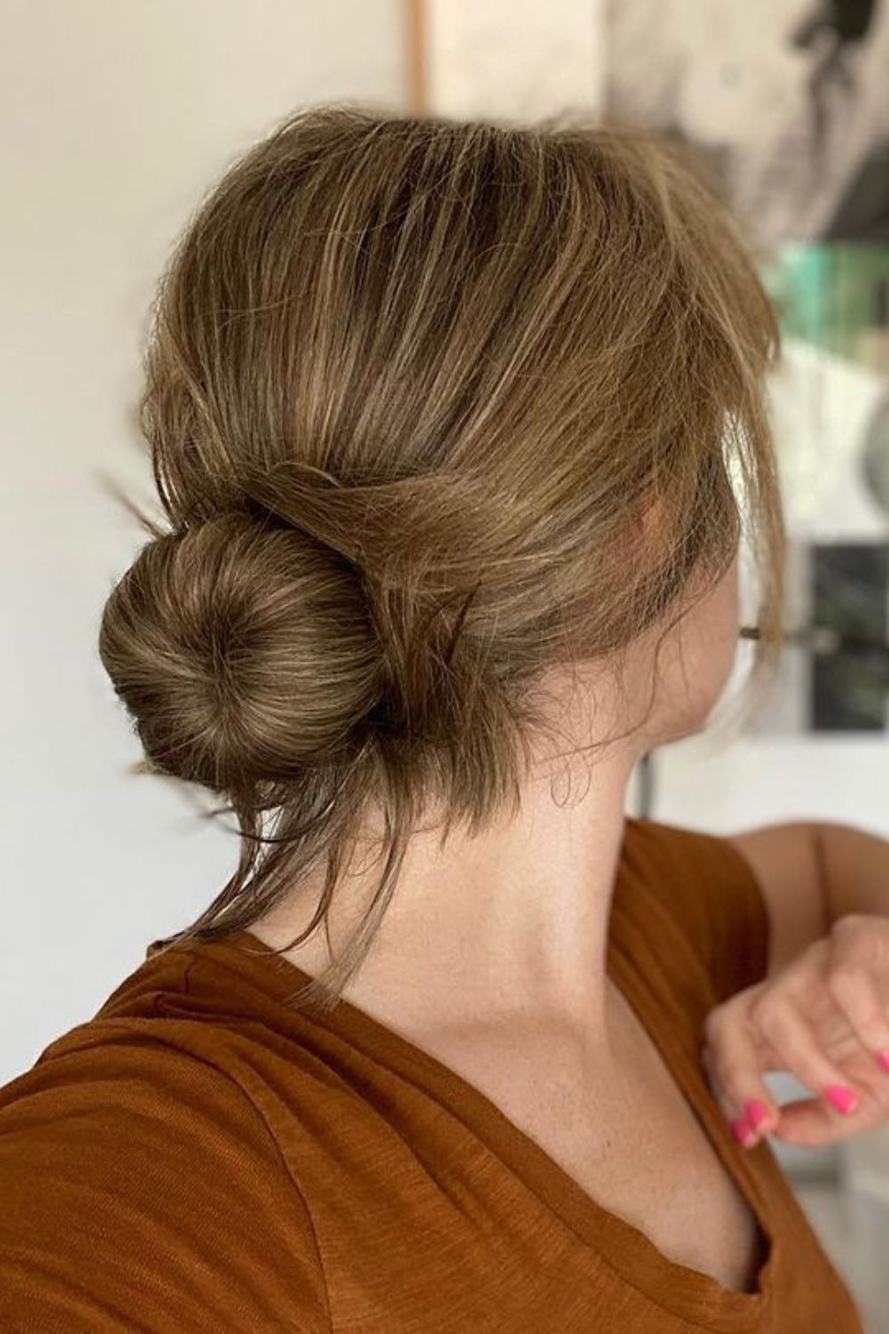 A woman with a low messy bun.