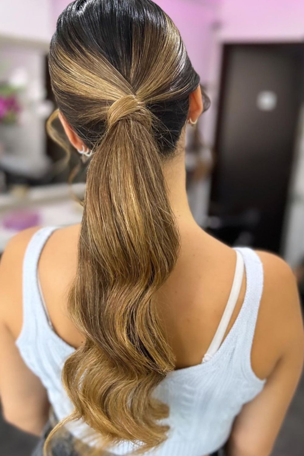 A woman with a long, blonde, low ponytail.