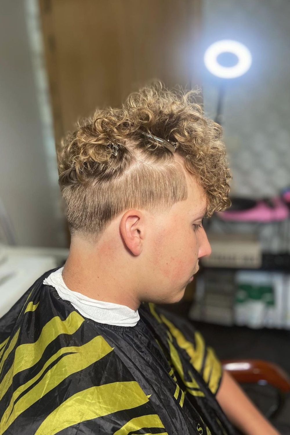 A man with a blonde low taper fade haircut.