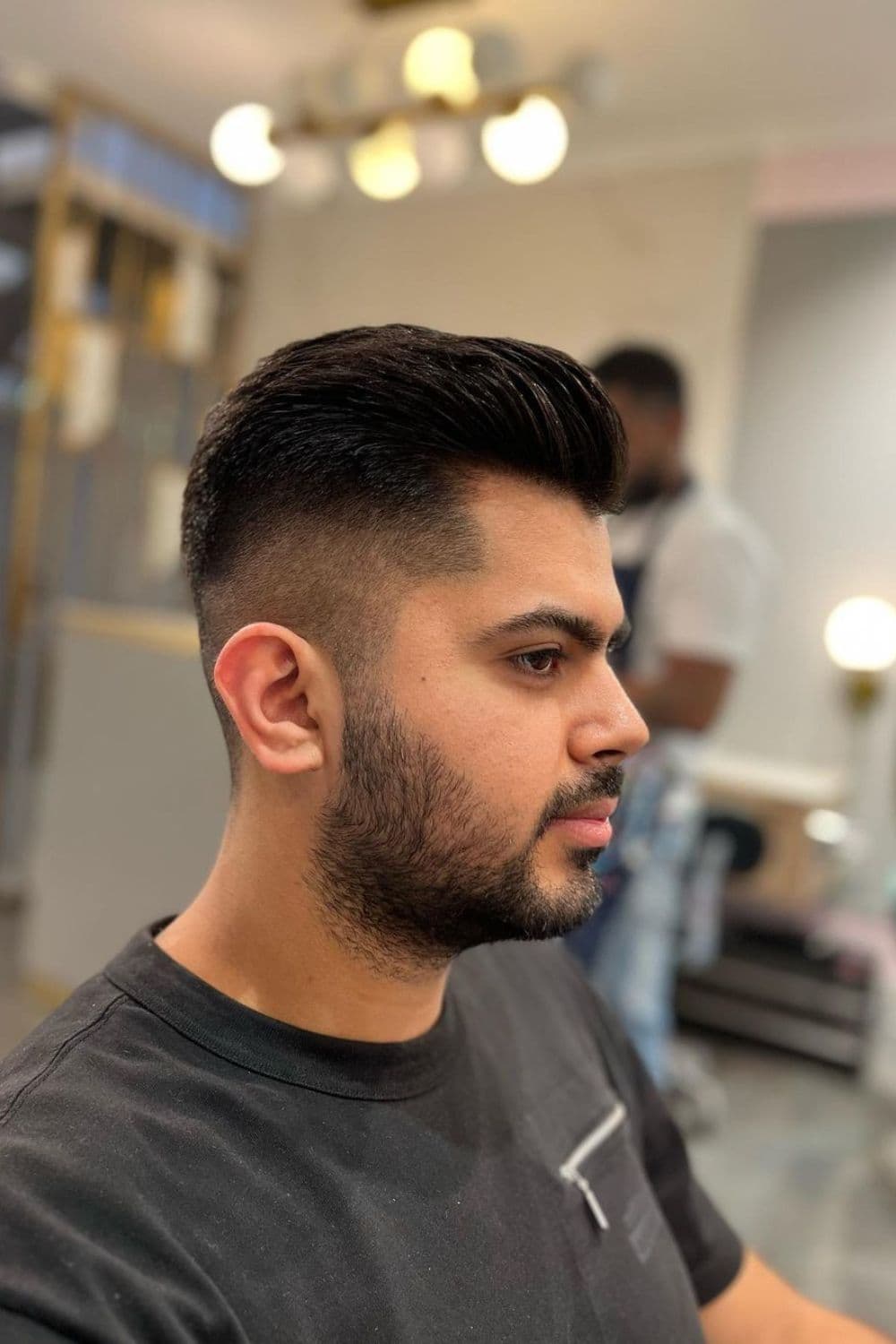 Side view of a man with medium fade cut.