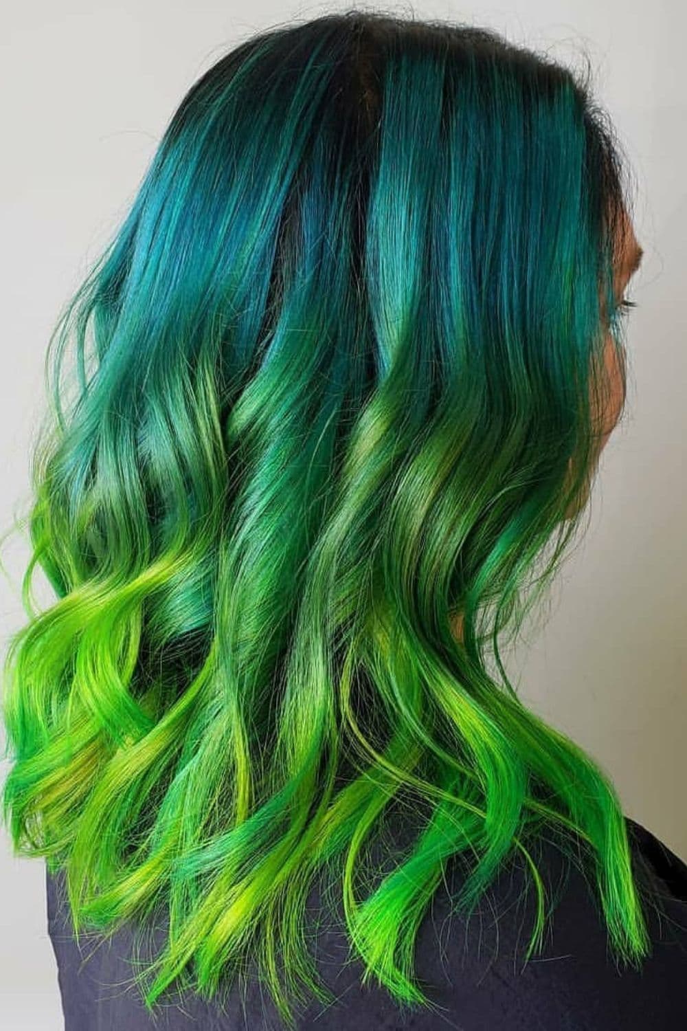 A woman with a mermaid green ombre hair.