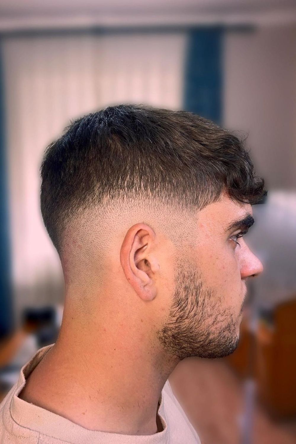 A man with a black mid-fade cut.