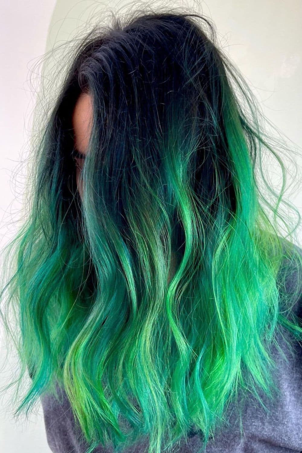 A woman with a multi-tone green ombre hair.