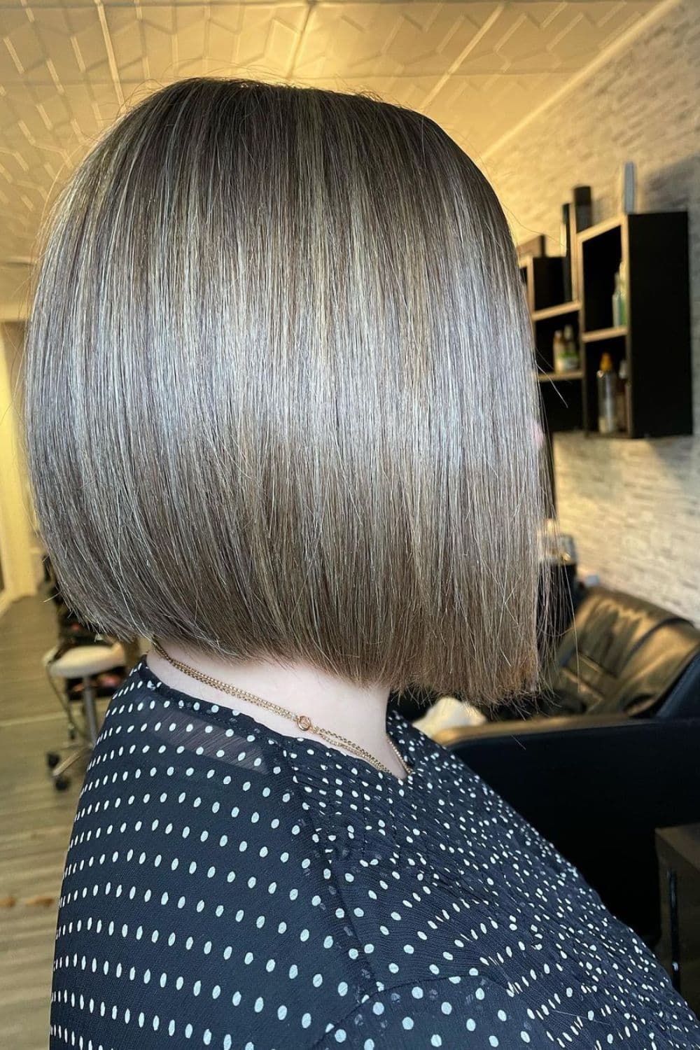 A woman with natural dirty blonde bob cut.