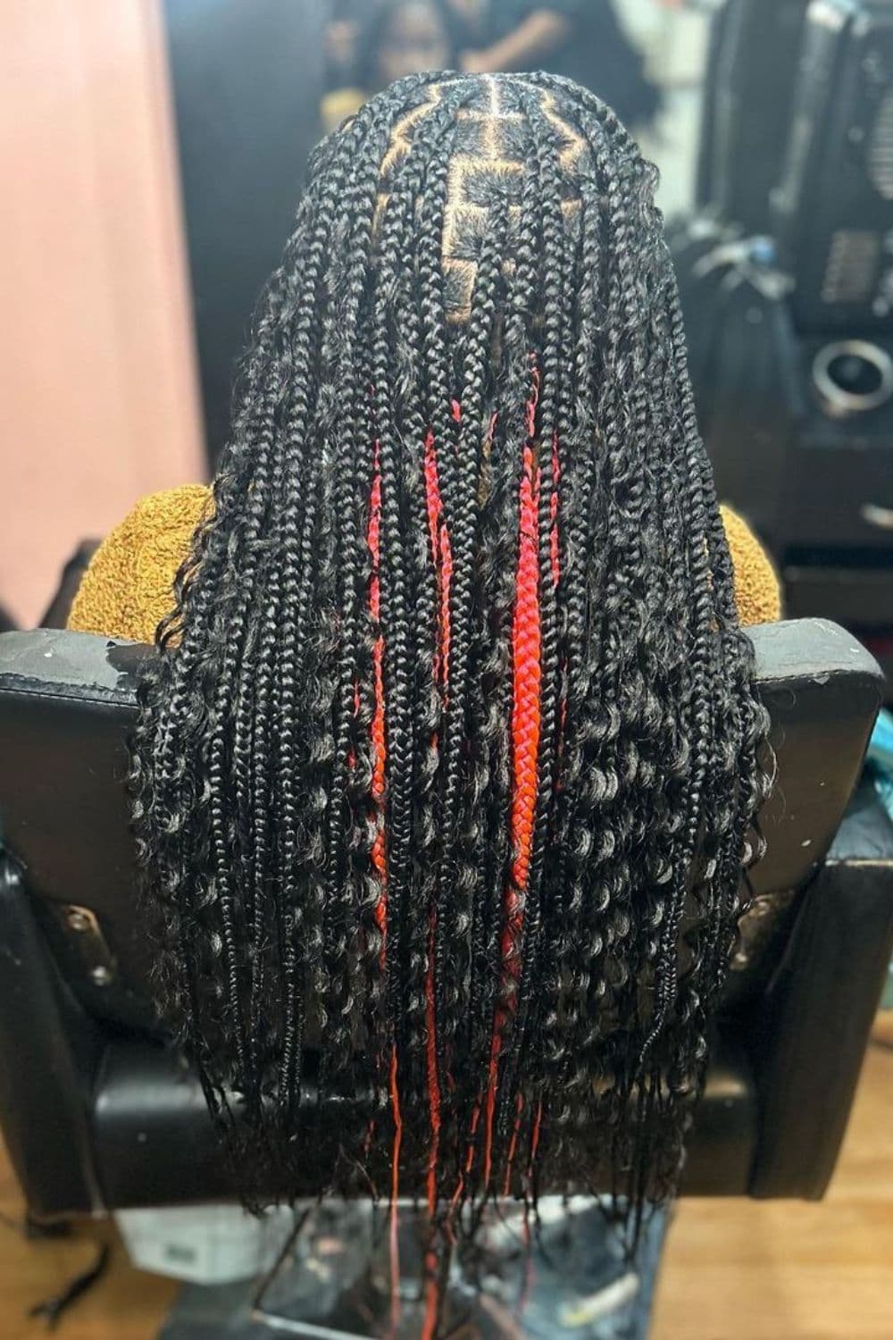 A woman with black and red peekaboo goddess braids.
