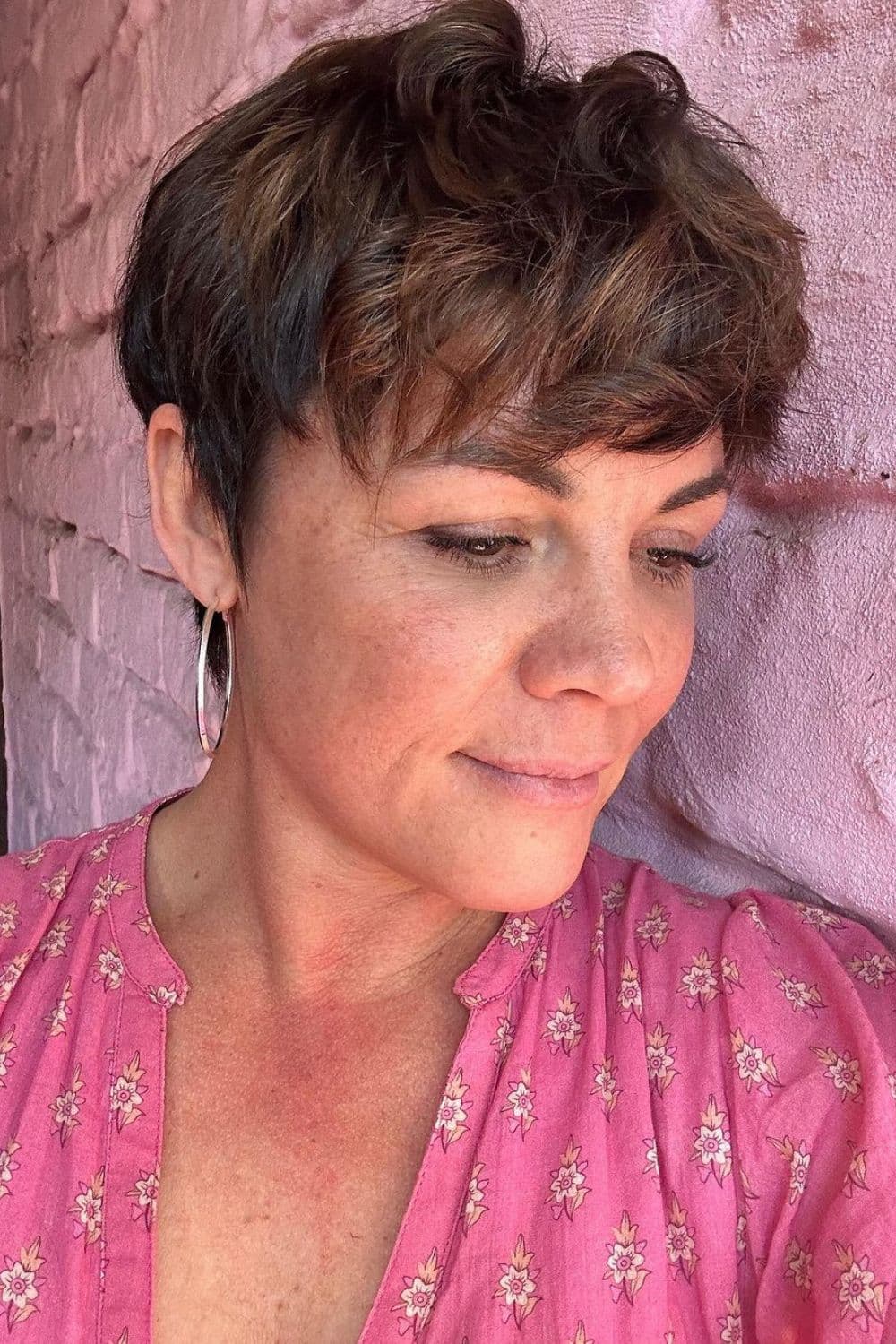 A woman with a brown pixie cut.