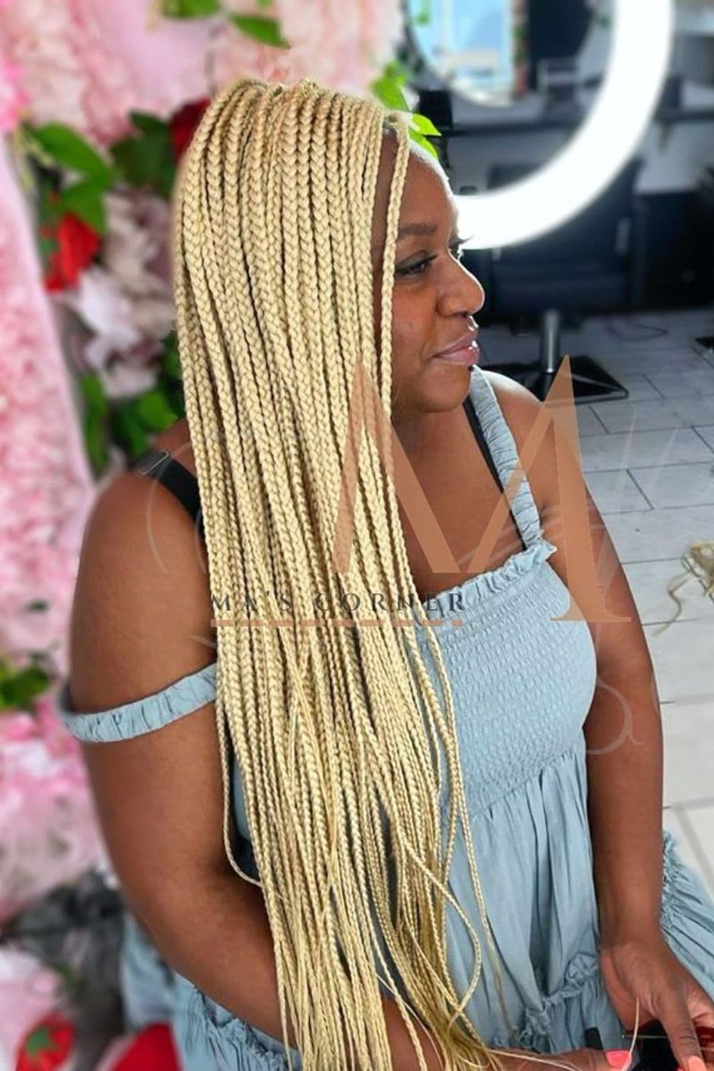 A woman with long platinum blonde knotless braids.