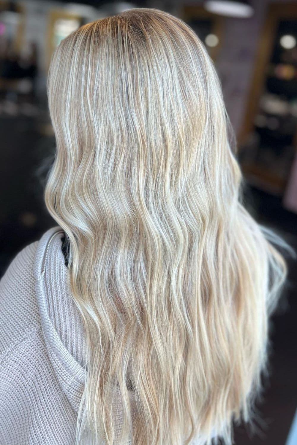 A woman with long platinum blonde hair with honey blonde highlights.