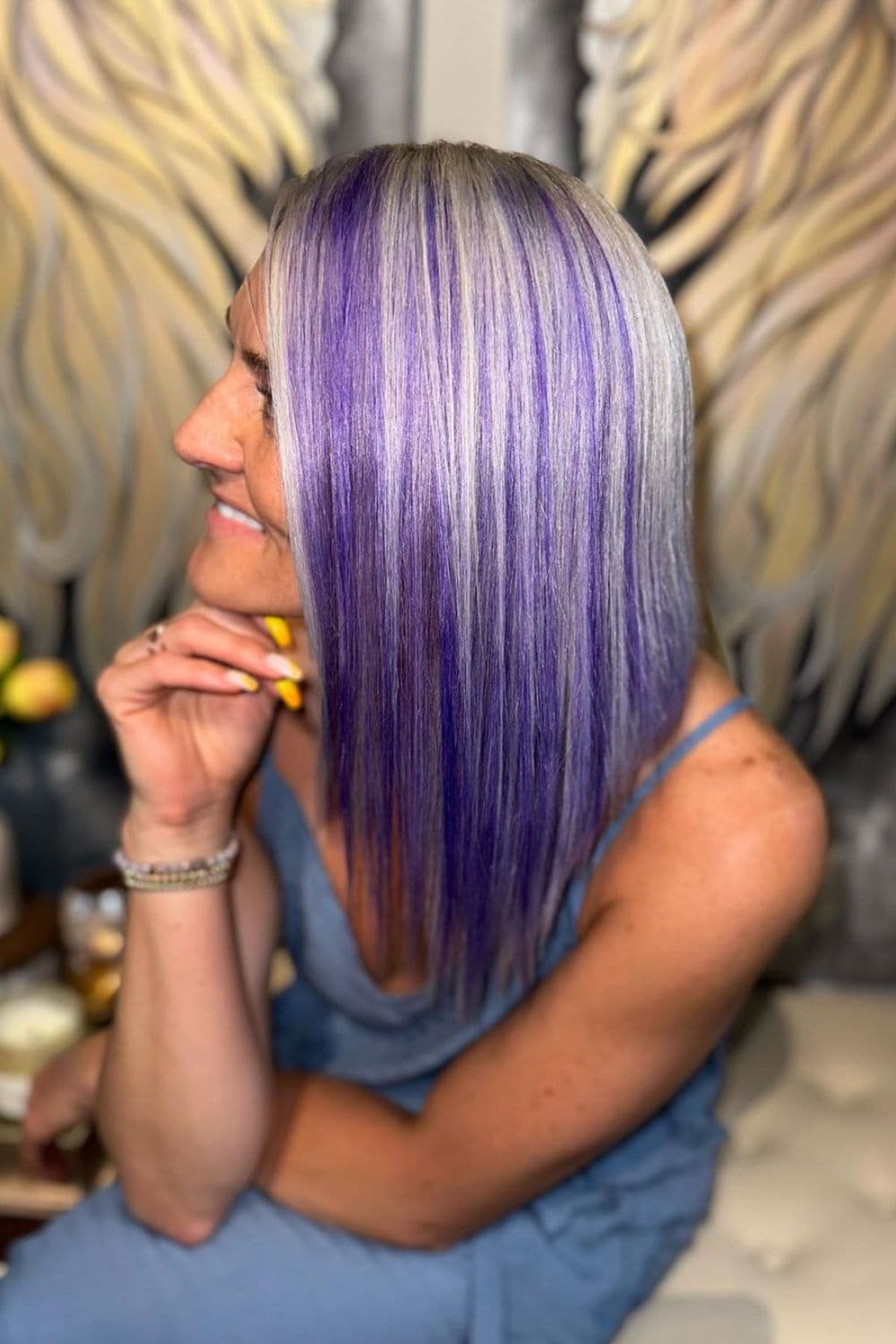 A woman with a platinum blonde and lavender long bob.