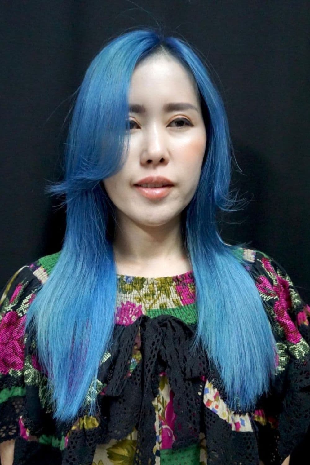 A woman with long platinum blue hair.