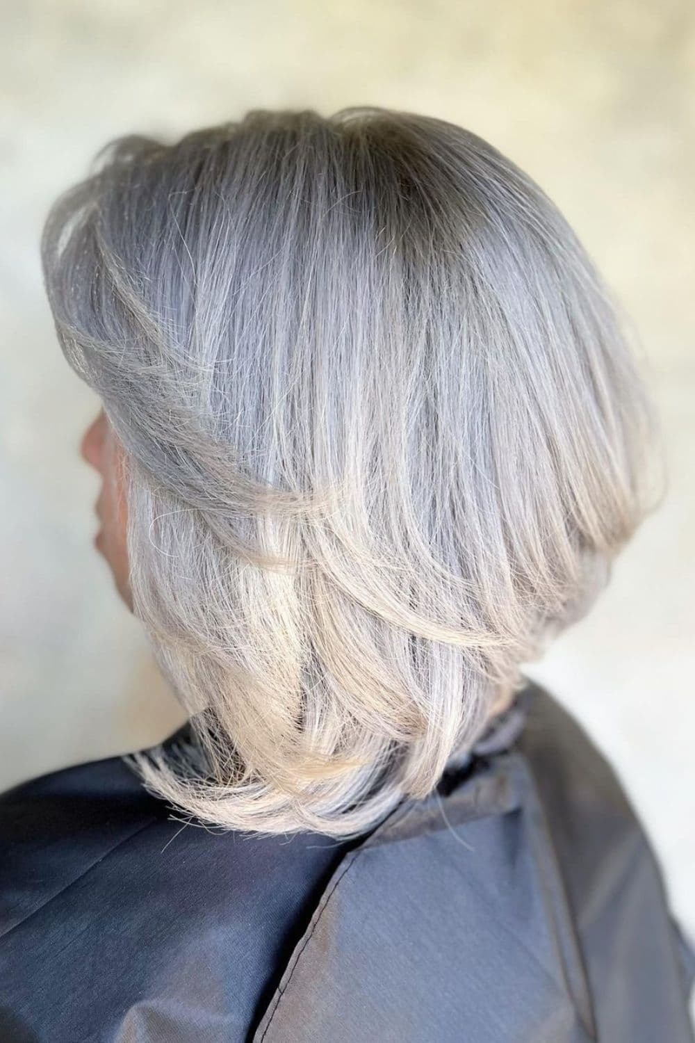 A woman with platinum silver bob hair.