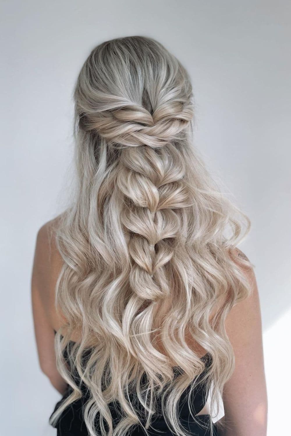 A woman with a long blonde pull-through braid.