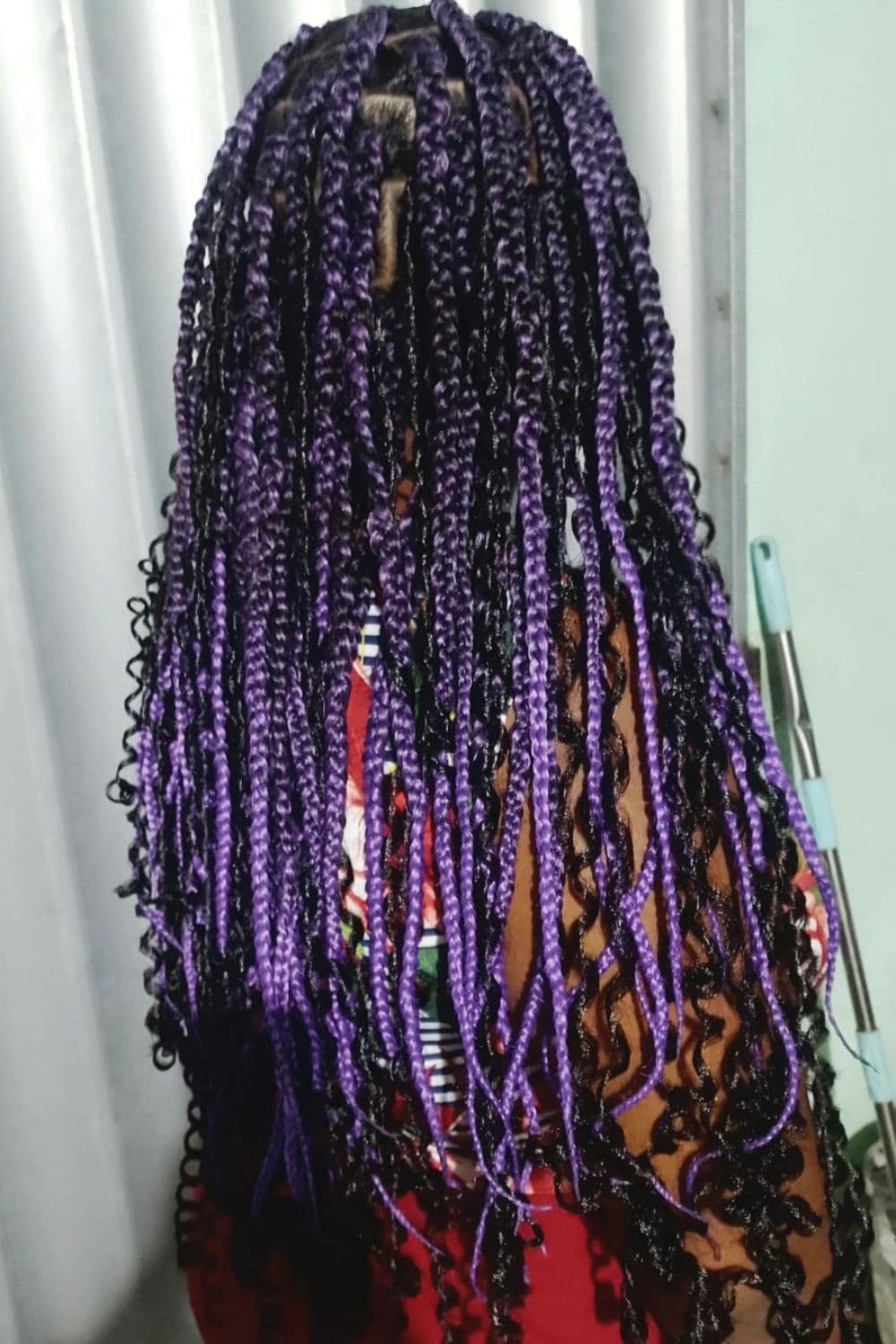 A woman with long purple goddess braids.
