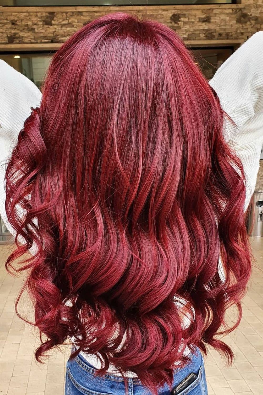 A woman with long wavy red apple hair.