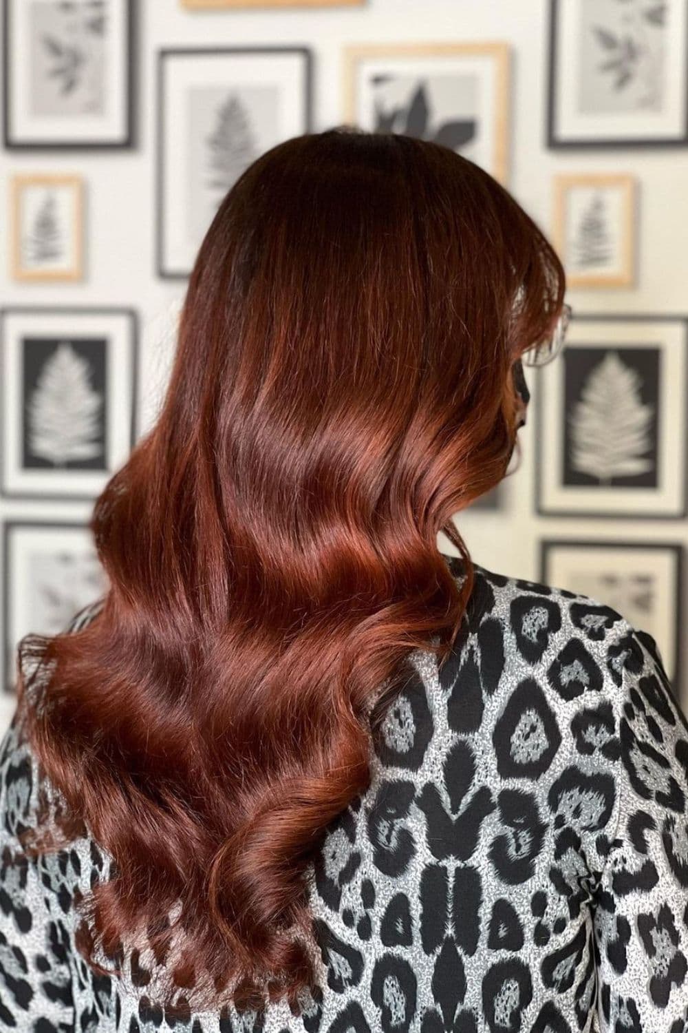A woman with long wavy rich auburn red hair.