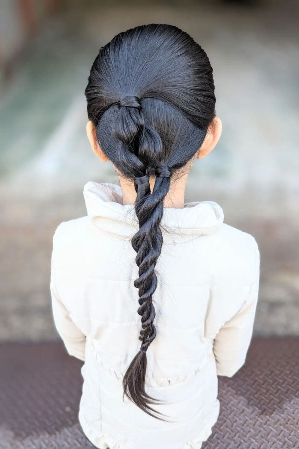 A girl with a long black rope braid.