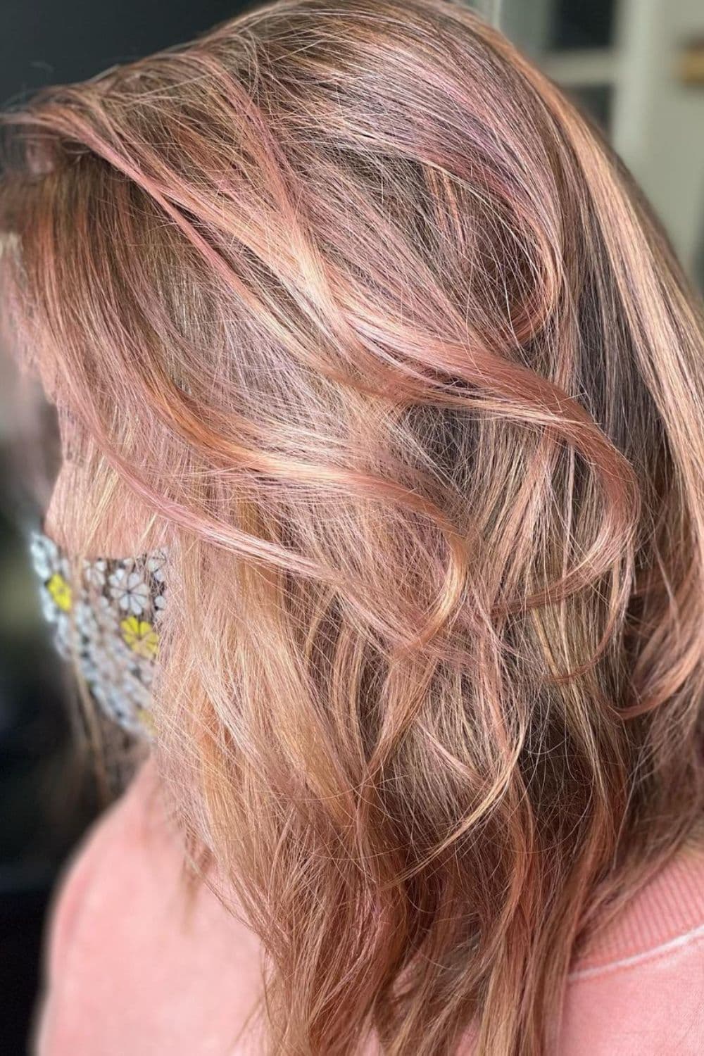 A woman with rose gold dirty blonde hair.