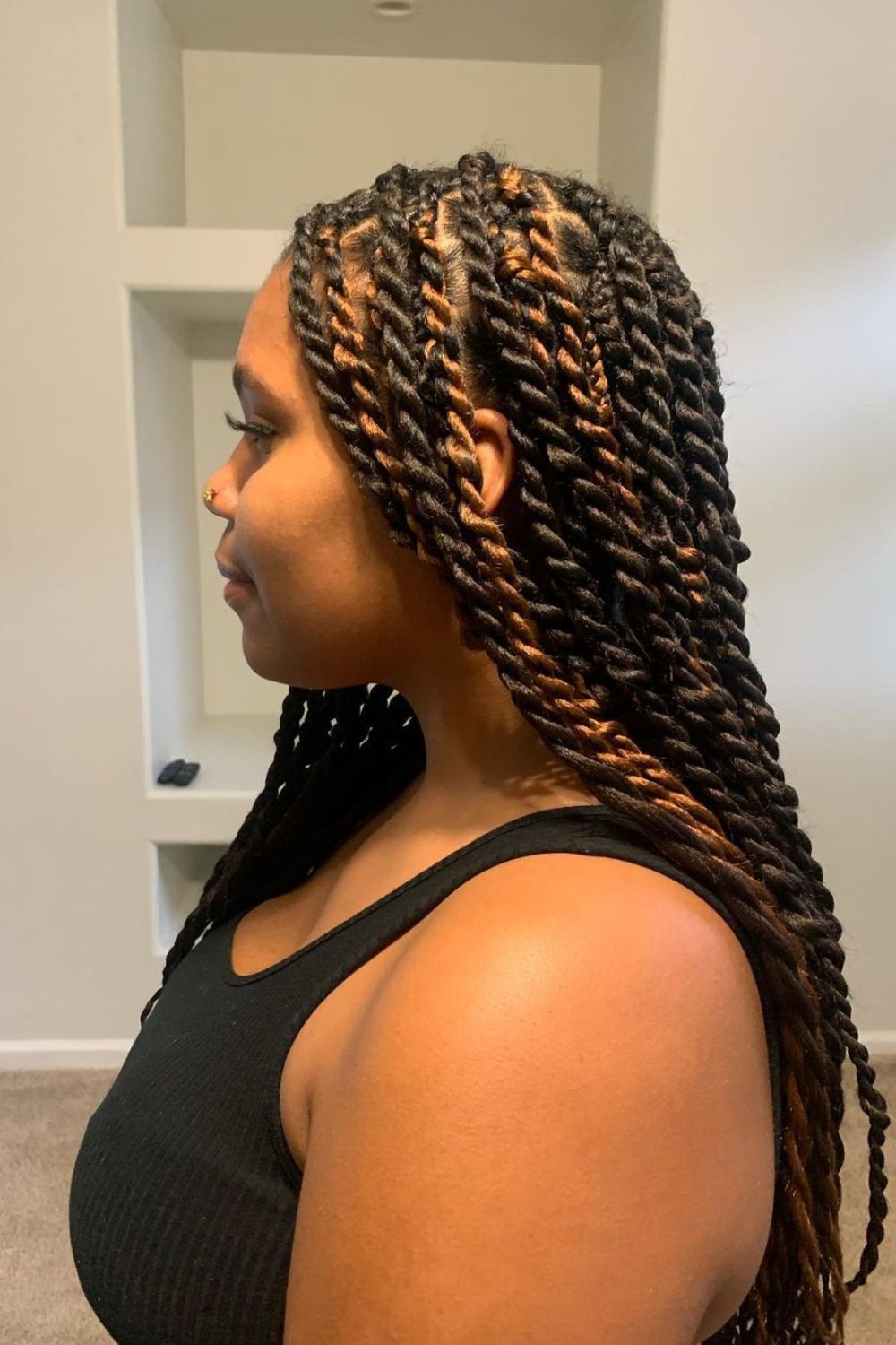 A woman with long Senegalese twists with highlights.