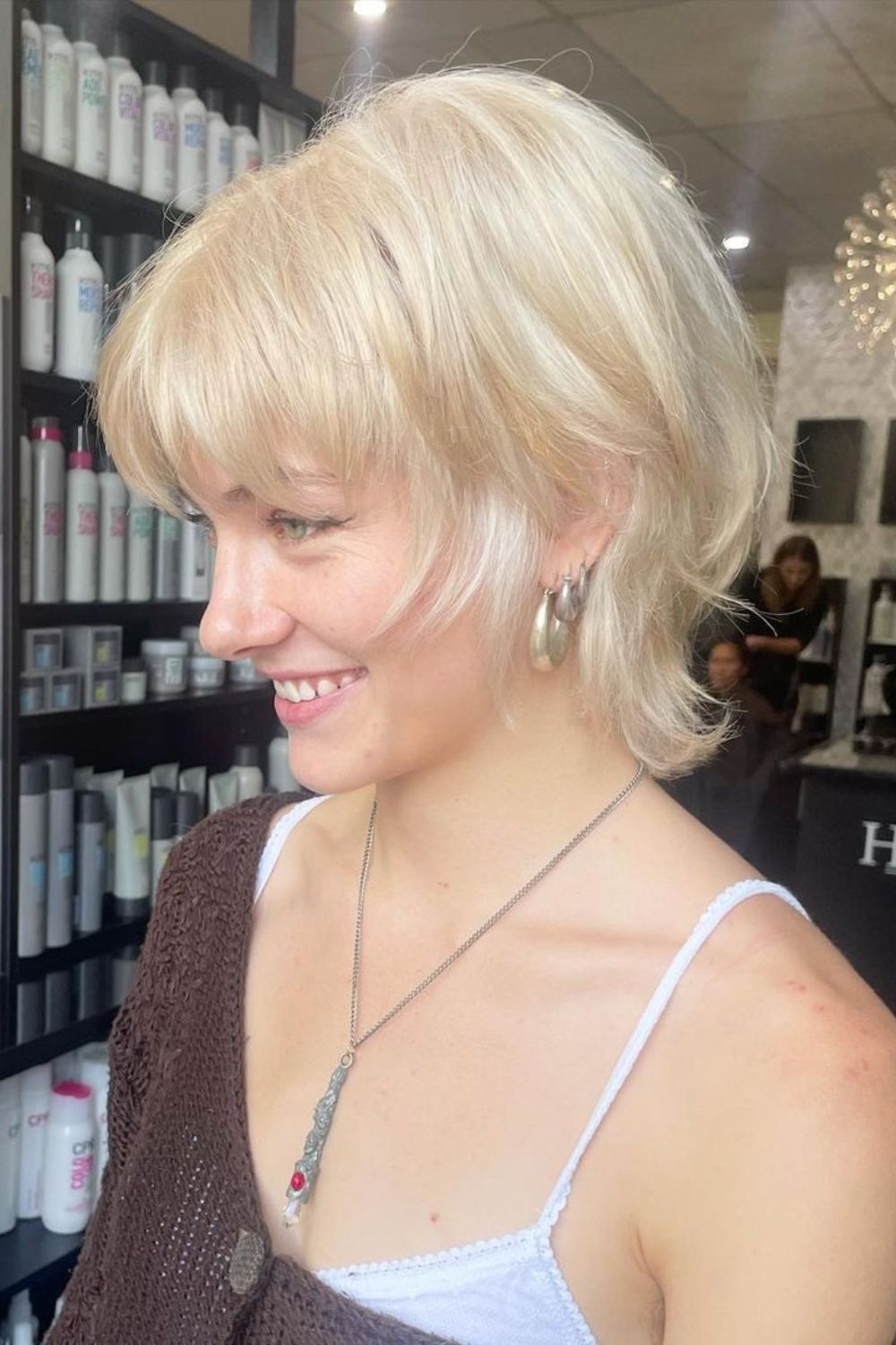 A woman with a short blonde wolf cut.