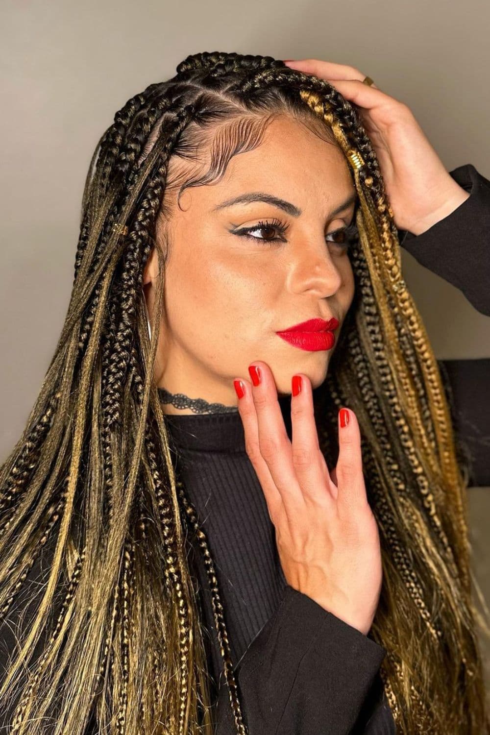 A woman with side-parted goddess braids.