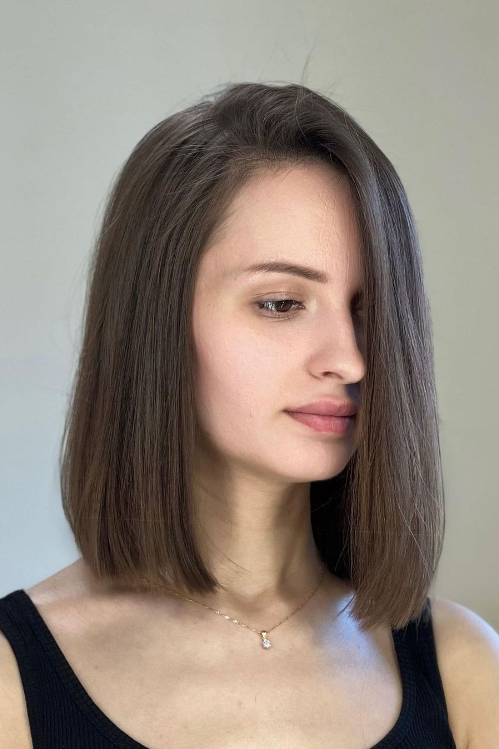 A woman with a brown side-swept lob.