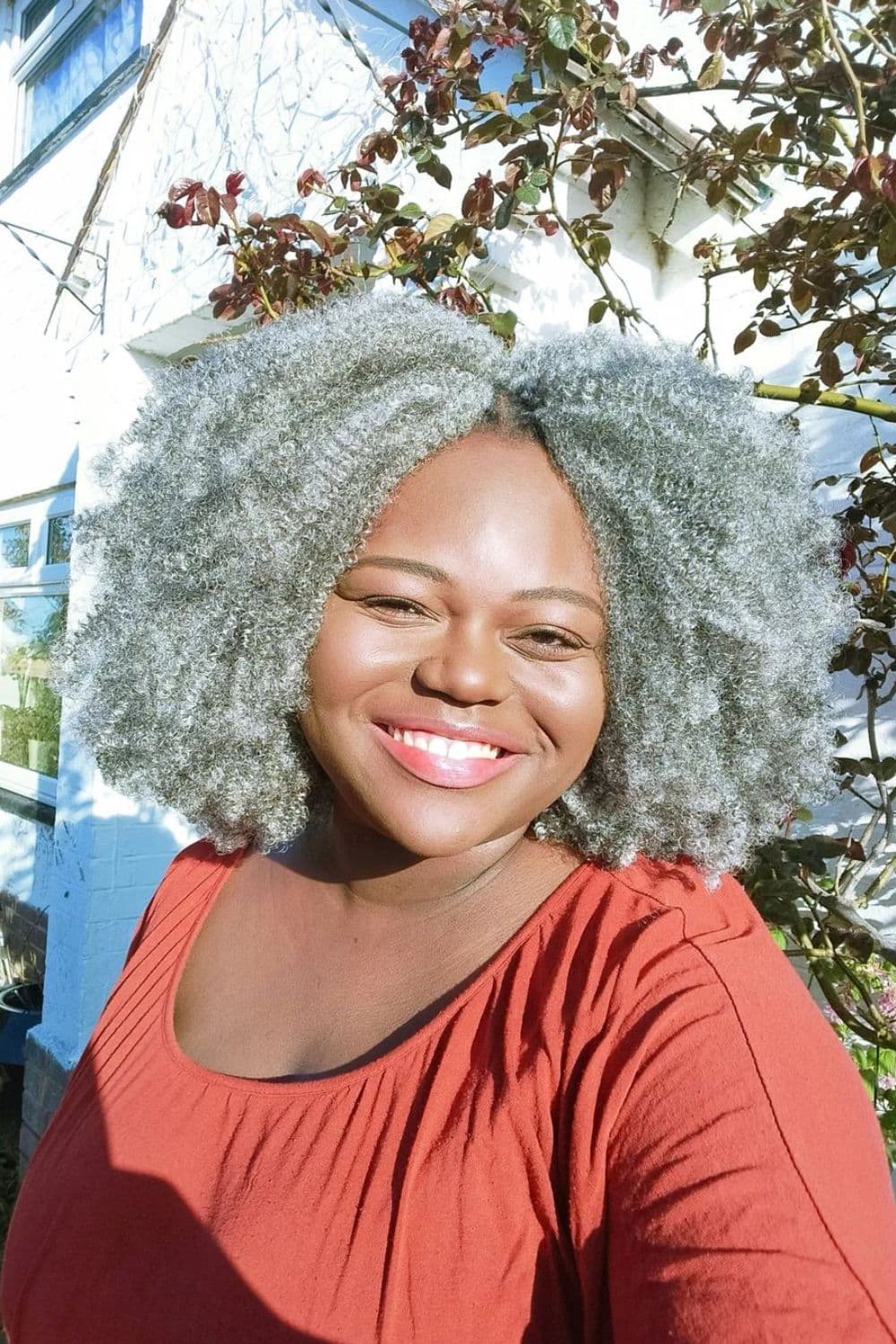 A woman with silver Afro-textured hair.