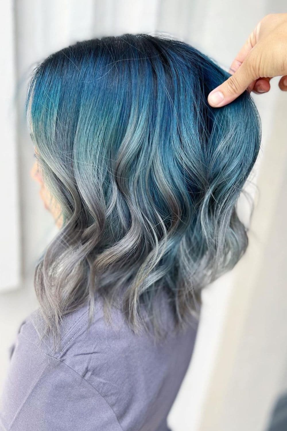 A woman with blue to silver ombre hair.
