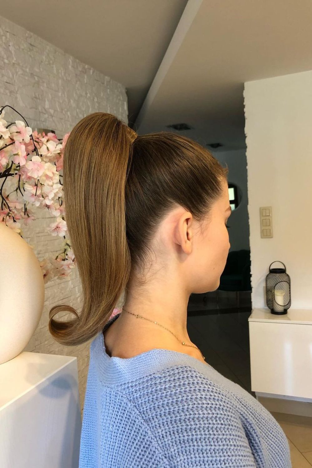 A woman with a sleek high ponytail.
