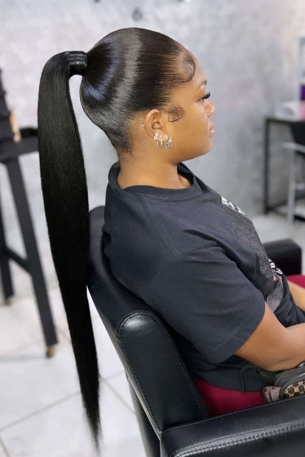 A woman with a long black sleek ponytail.
