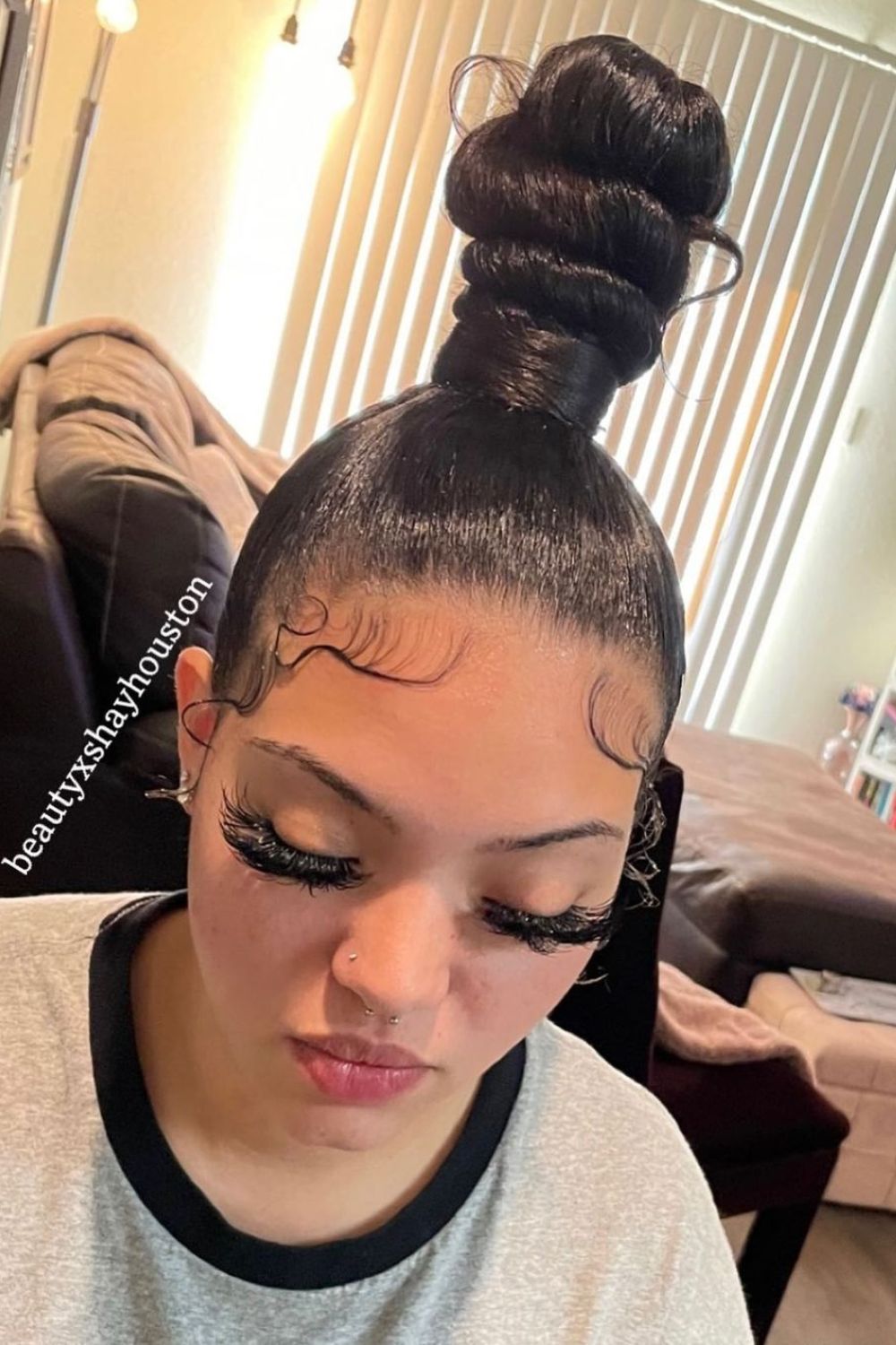 A woman with a black sleek top knot.