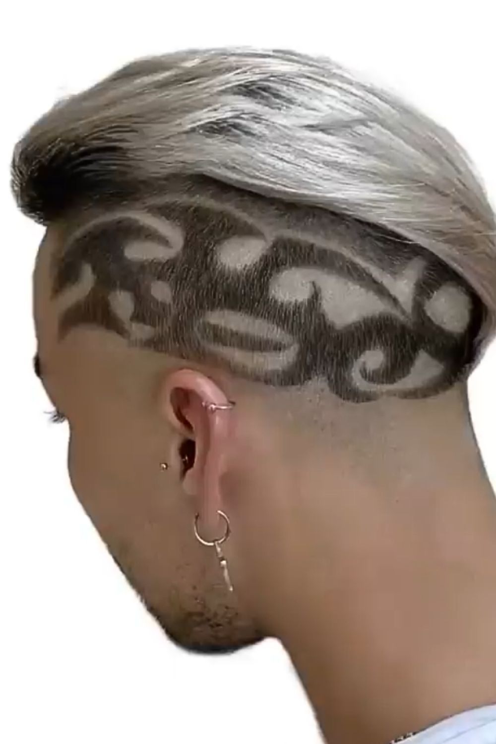 A man with a silver slick back hair with hair tattoos.