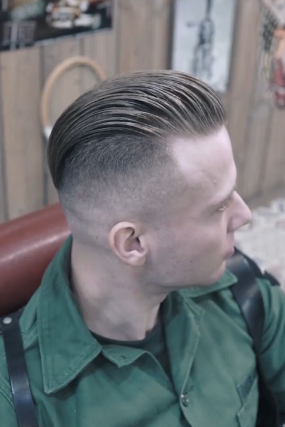 A man with a blonde slicked back disconnected undercut.