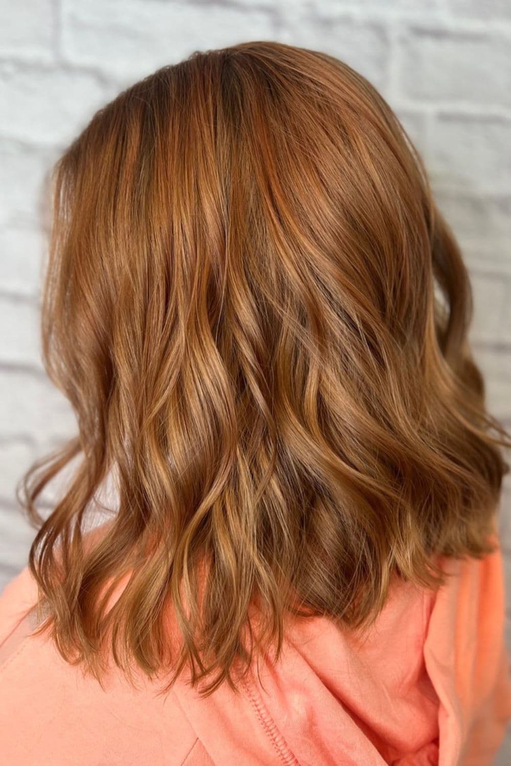 A woman with a strawberry blonde lob.