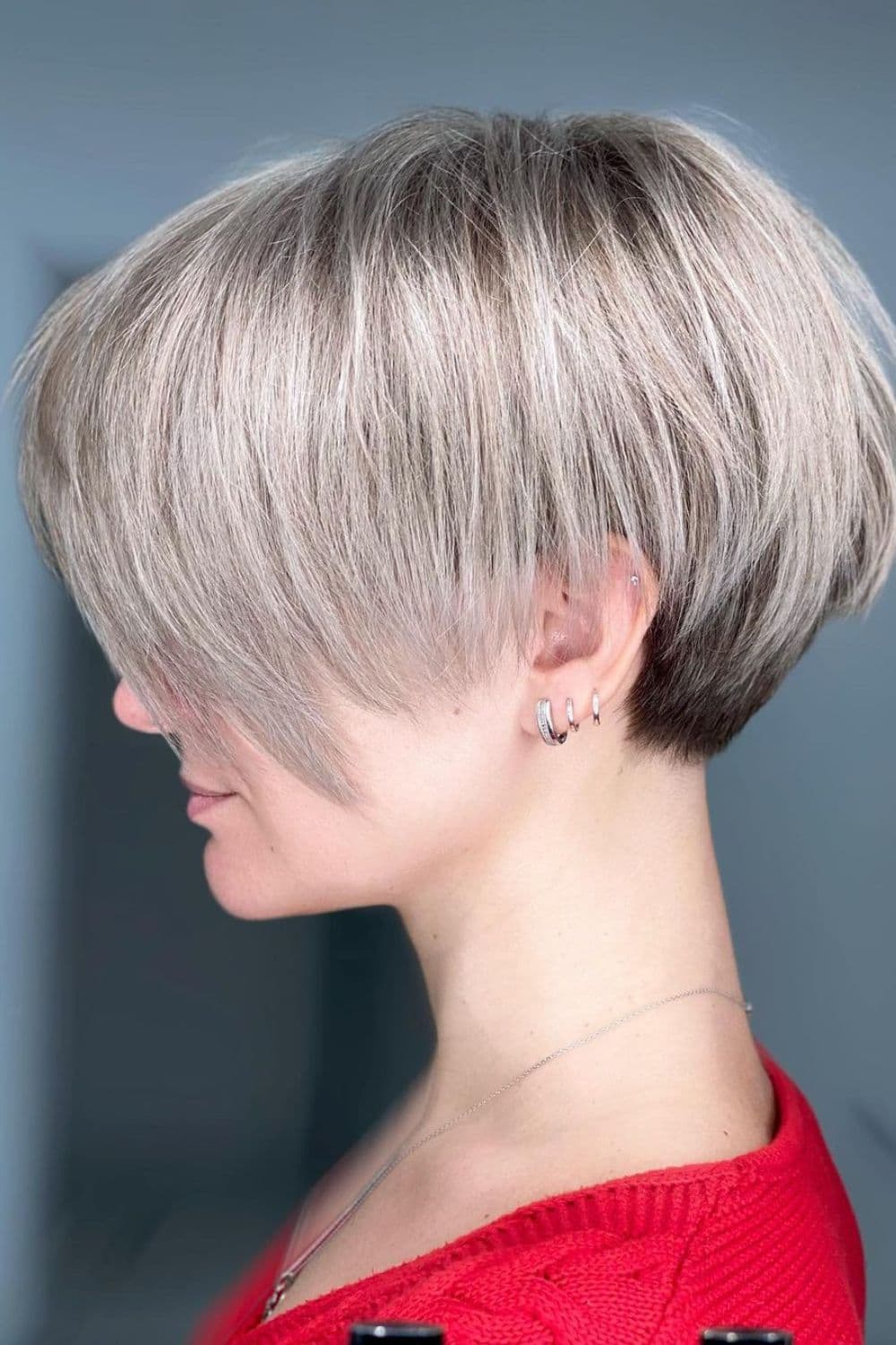 A woman with a gray tapered bixie cut.