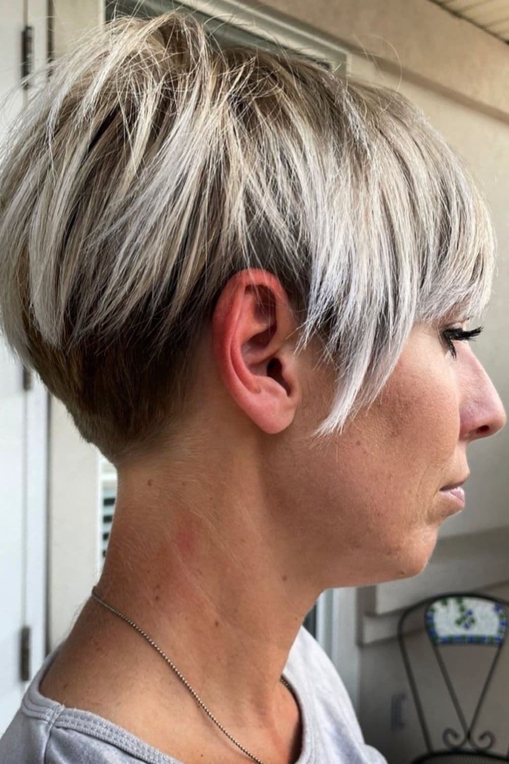A woman with a tapered bixie cut.
