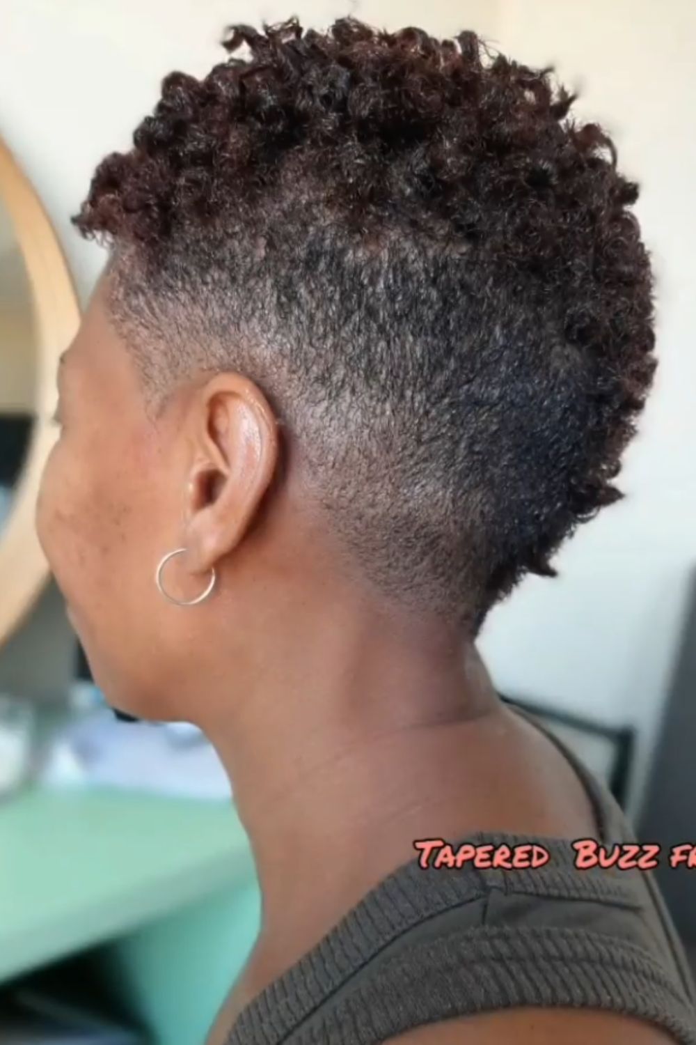 A black woman with a tapered frohawk.