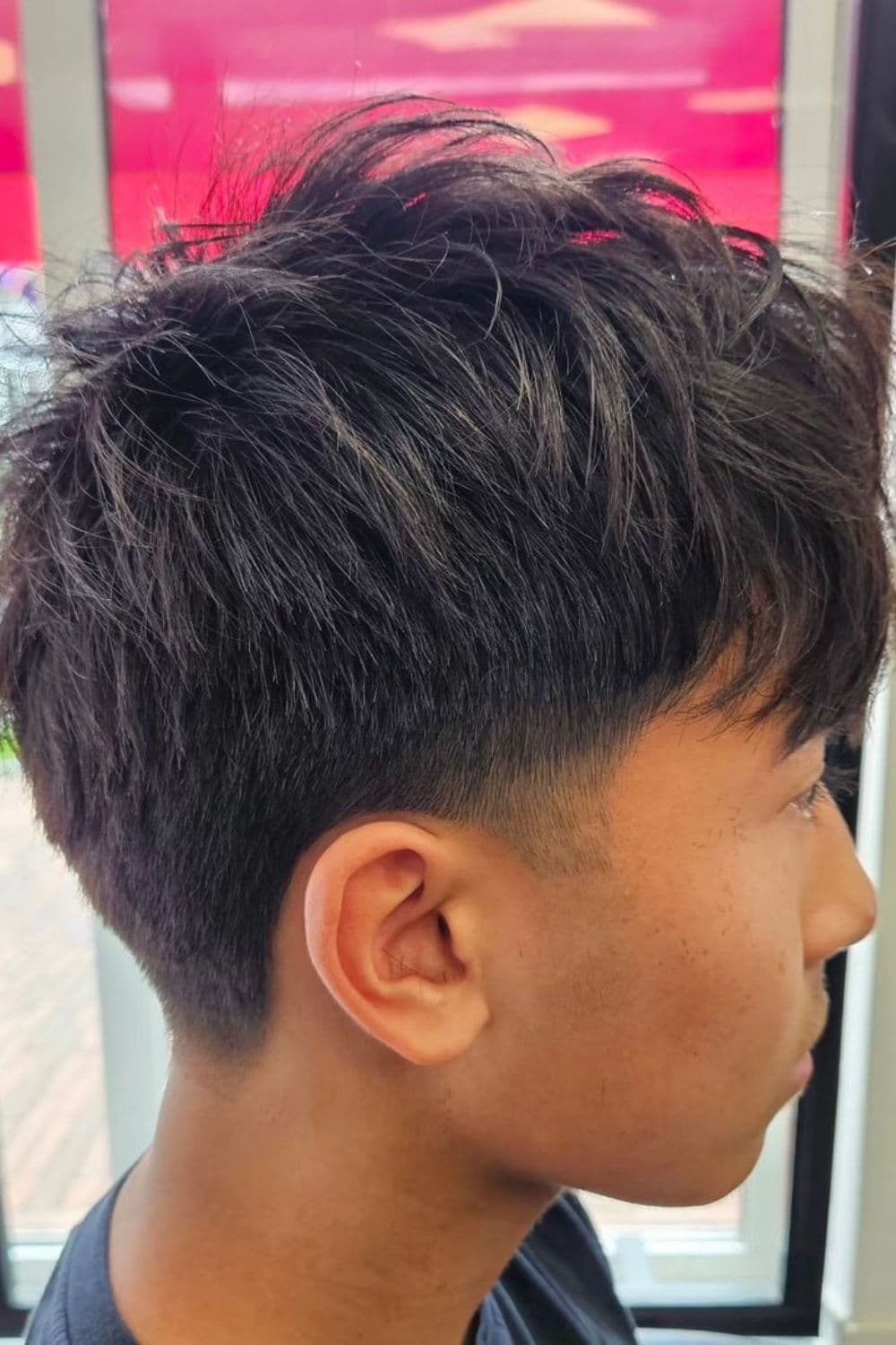 Side view of a man with a temple fade haircut.