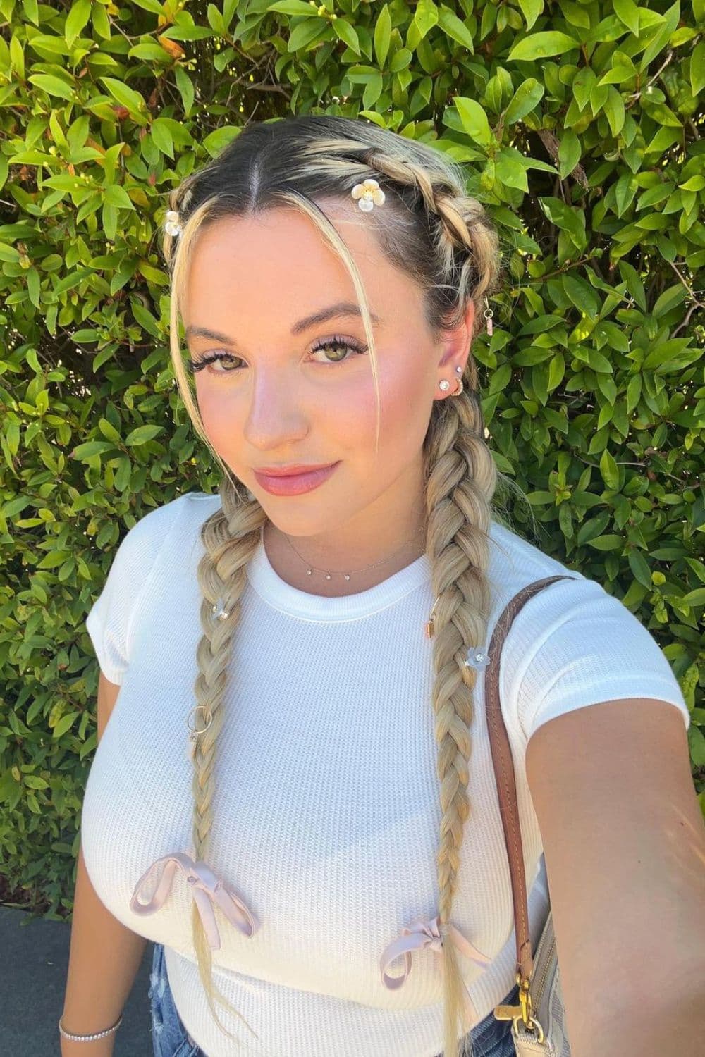 A woman with long blonde two French braids.