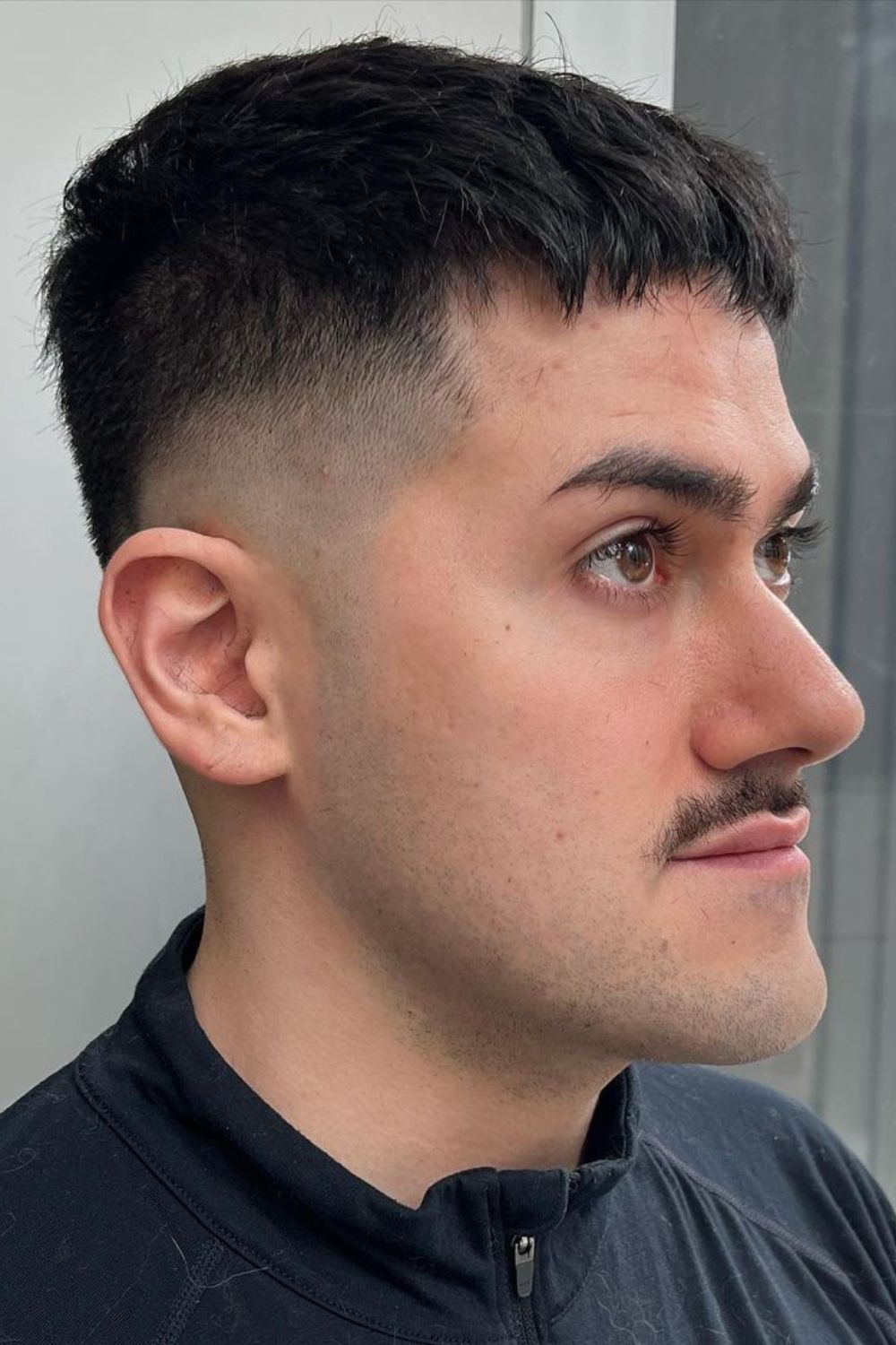 A man with a Caesar haircut.