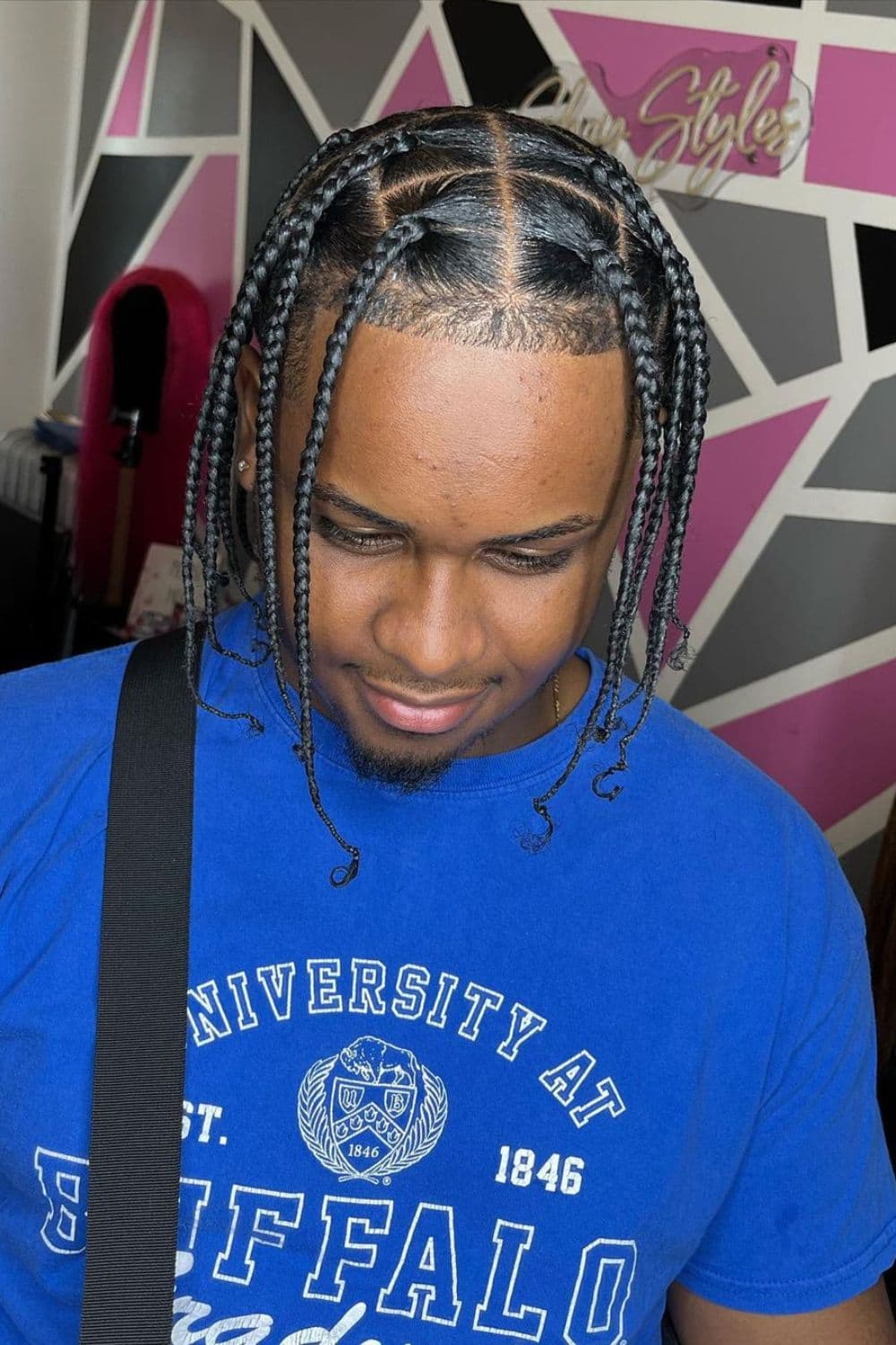 A man with chin-length box braids.