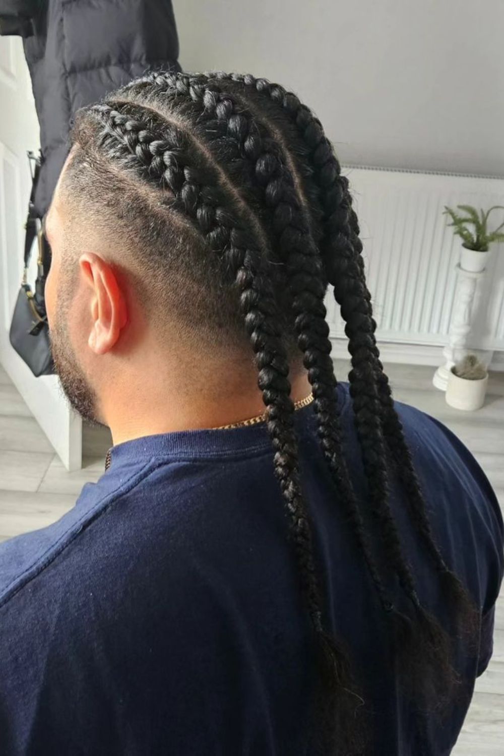 A man with long chunky braids.