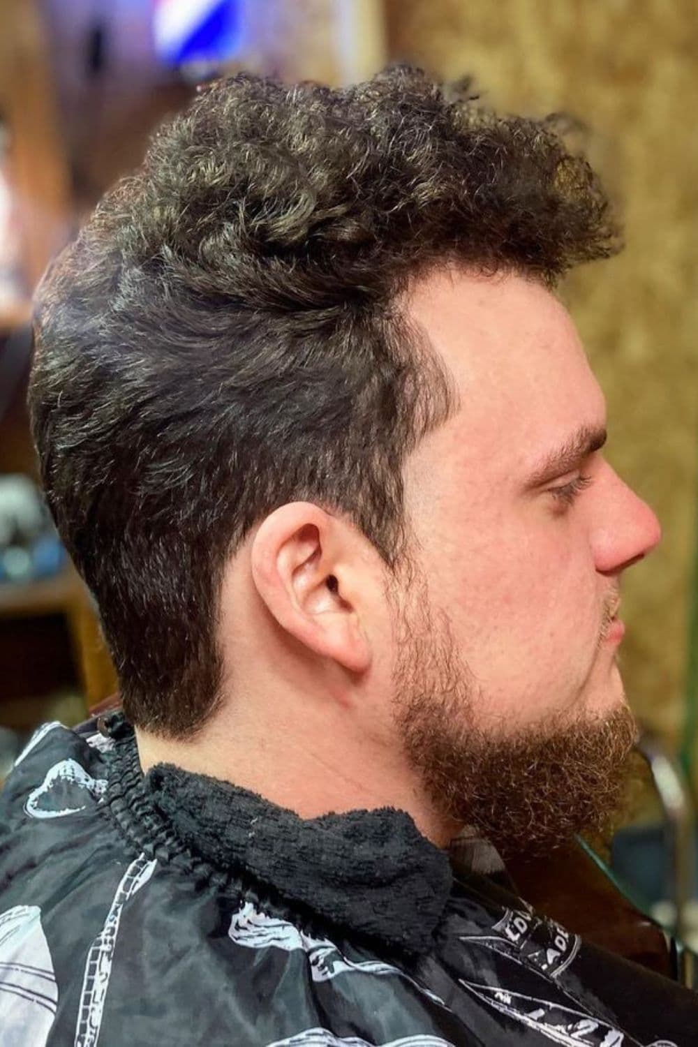 A man with a curly crew cut.