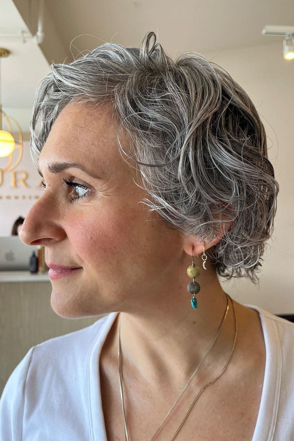 A woman with a gray curly French bob.