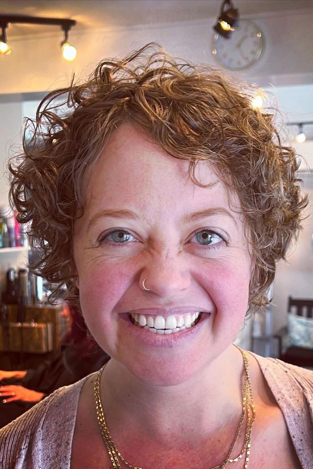 A woman with a brown curly shag bob.